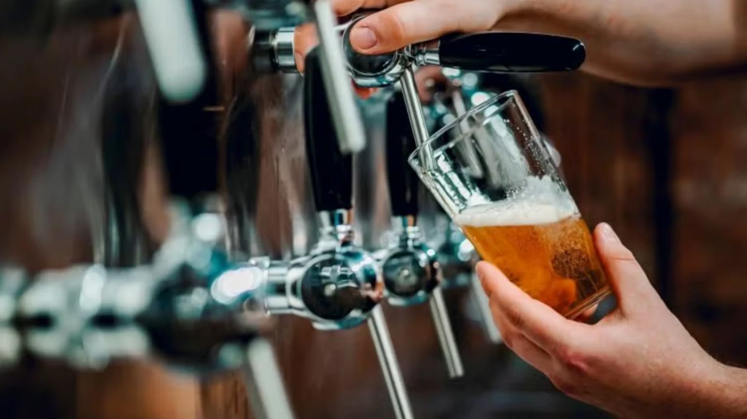 Pouring a fresh craft beer from the taps at Lucky Dogs